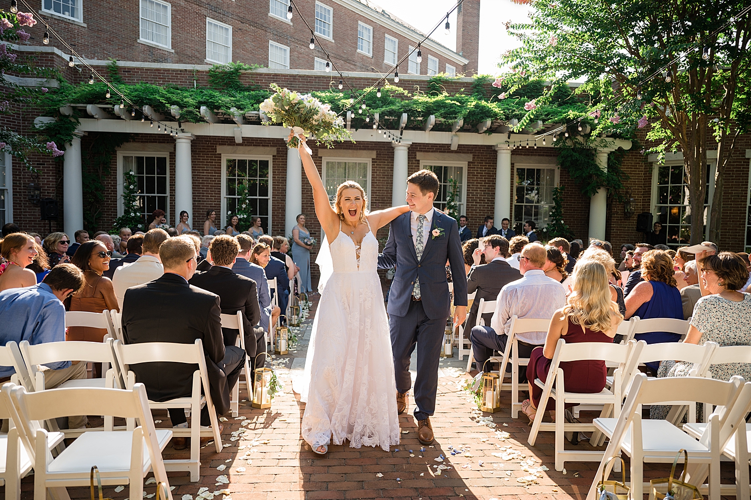 bride and groom recess from ceremony bouquet in the air