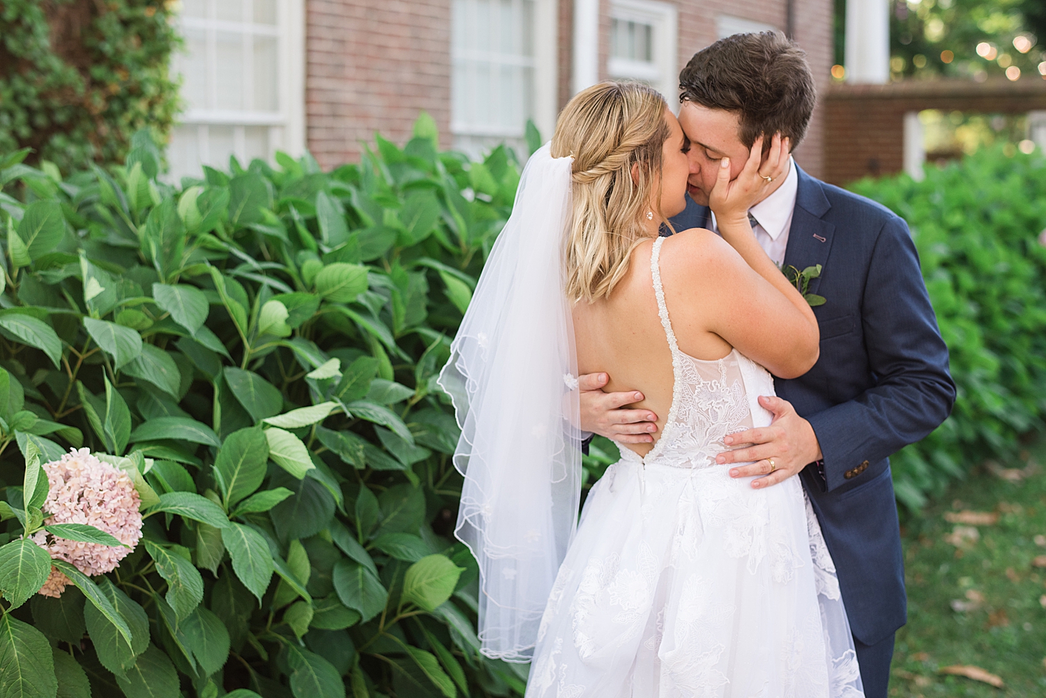 bride and groom embrace almost kiss