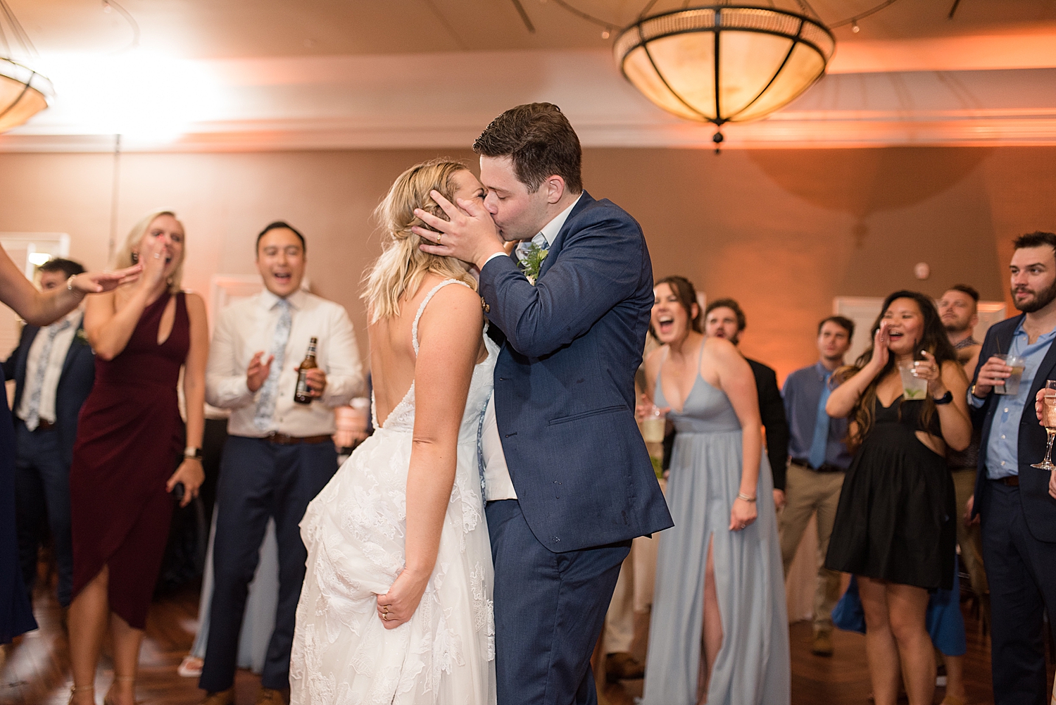 bride and groom kiss on dance floor