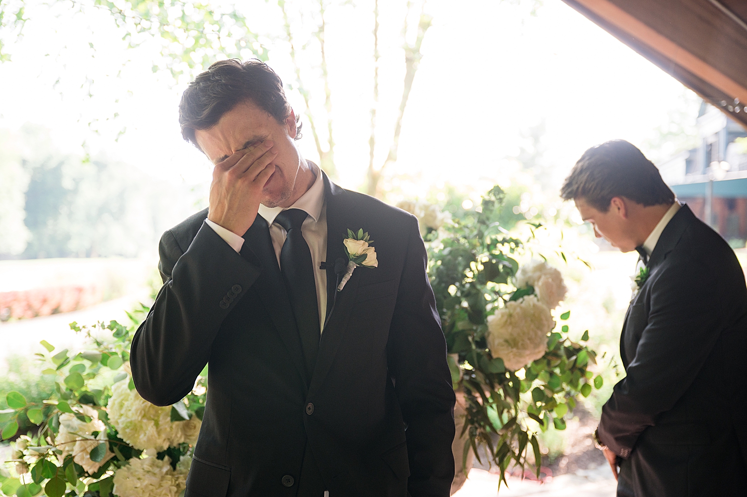 groom crying waiting for his bride at the end of the aisle