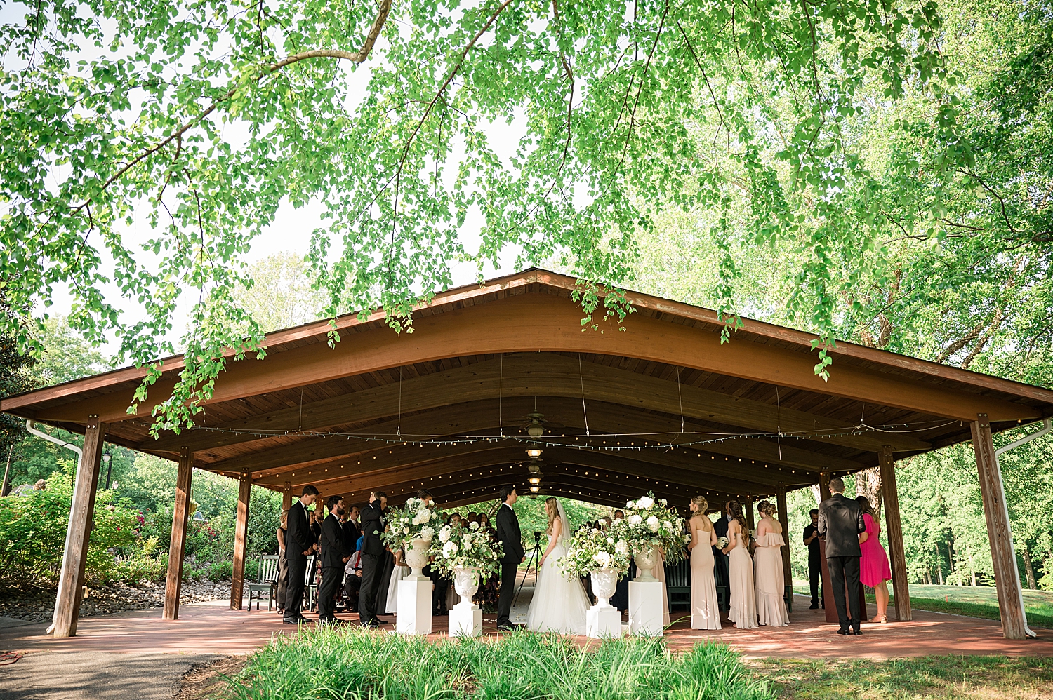 wide shot of ceremony under pavilion at golf club