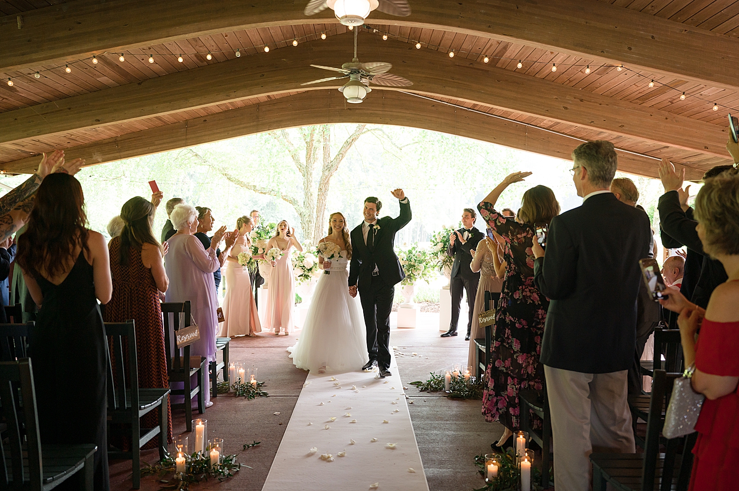 bride and groom celebrate as they recess ceremony