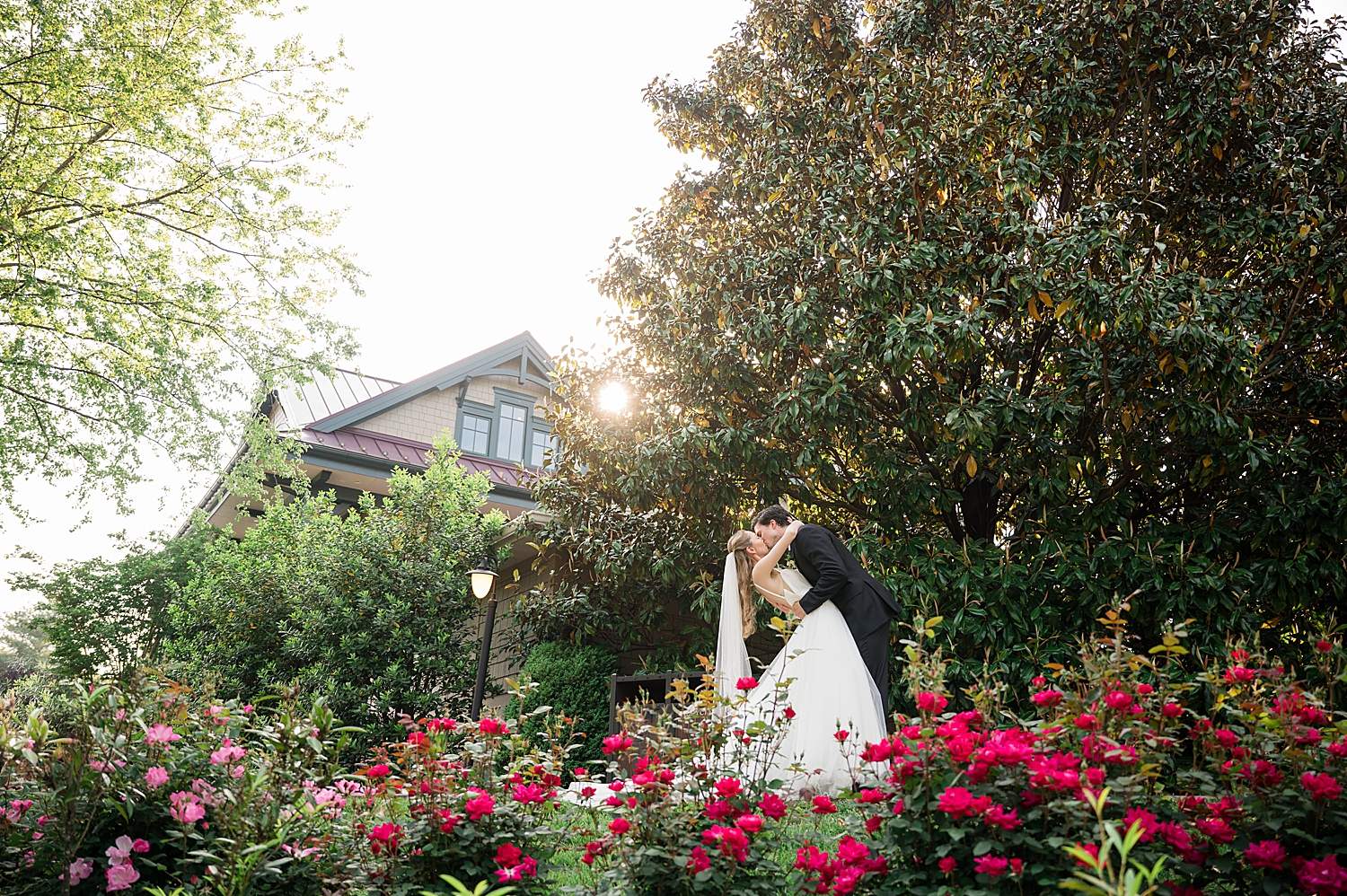 bride and groom kiss in garden