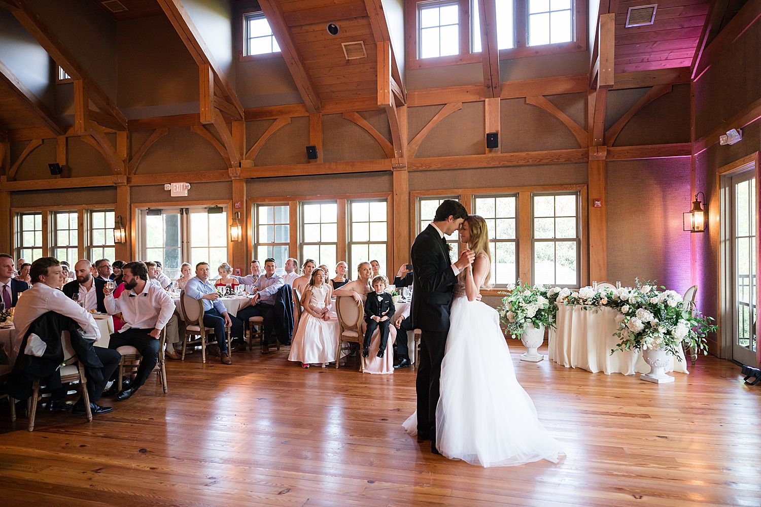 bride and groom first dance in golf club ballroom