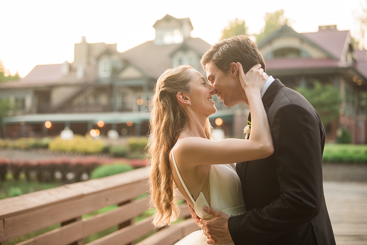 couple portrait embrace on bridge with golf club in the background