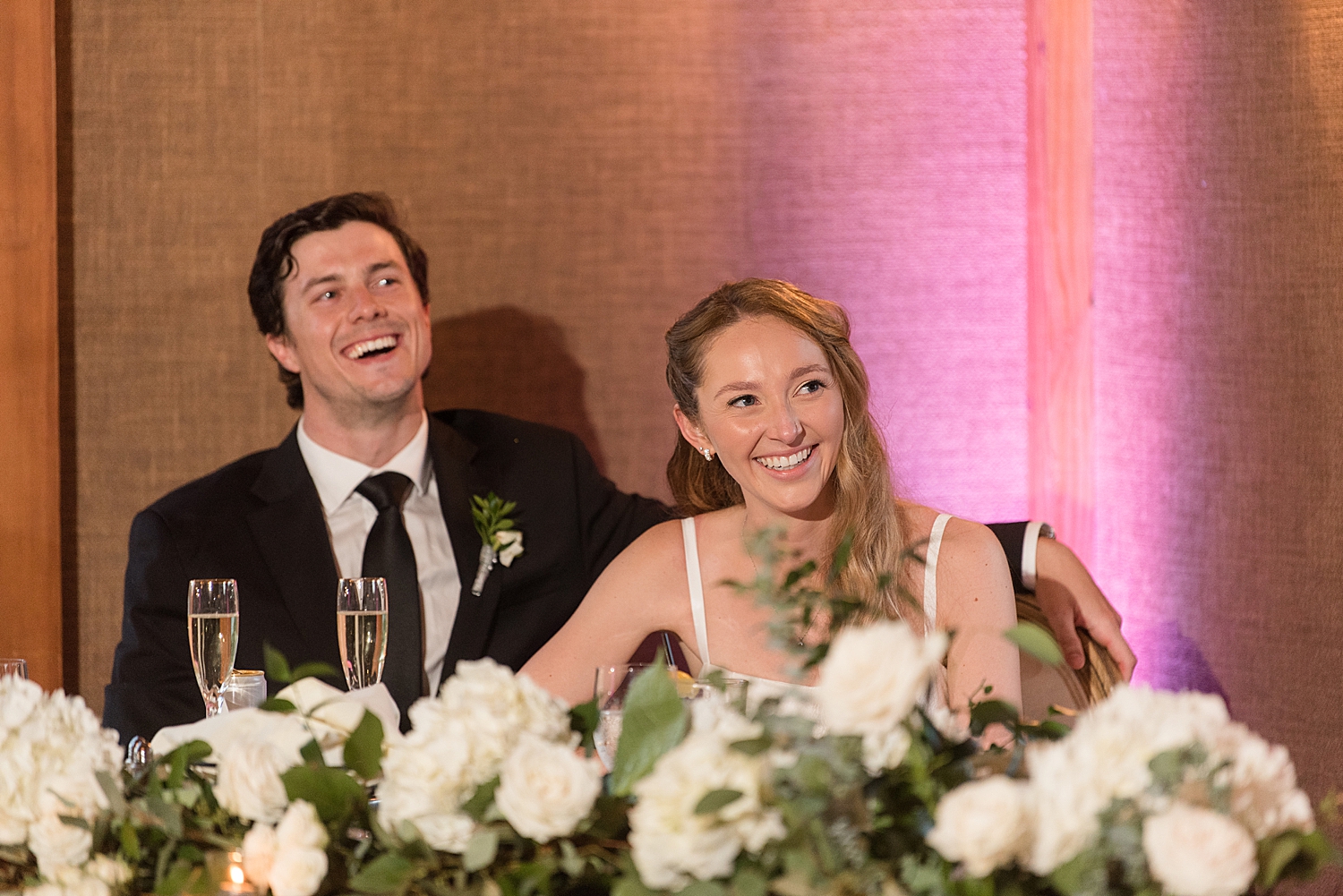 bride and groom laugh at toasts