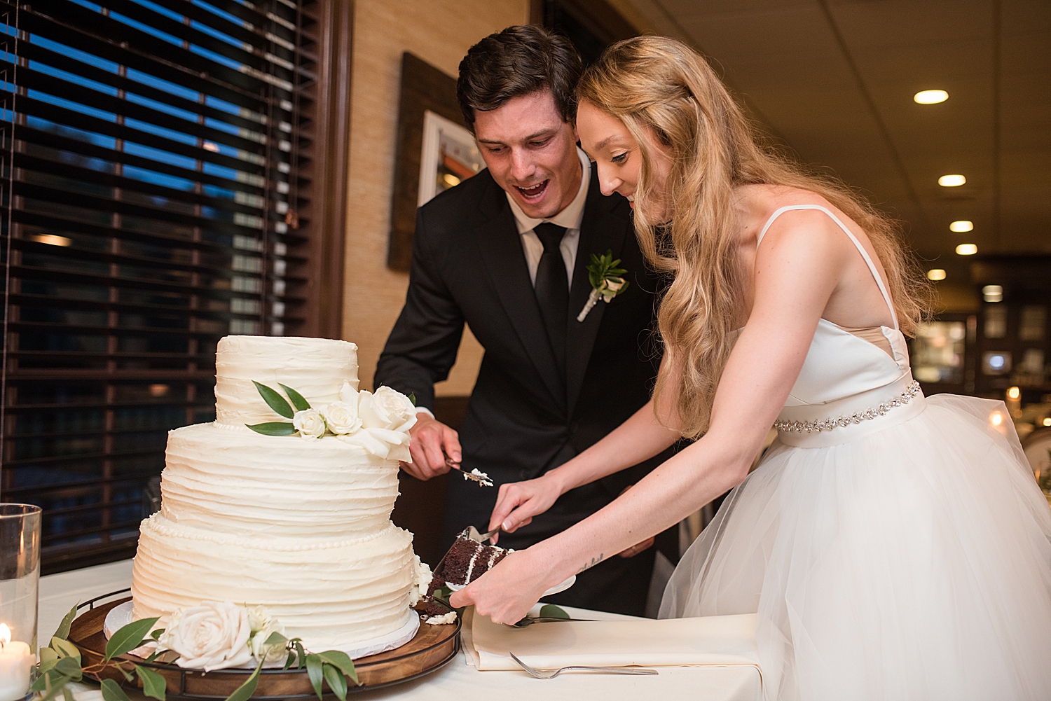 bride and groom cut the cake