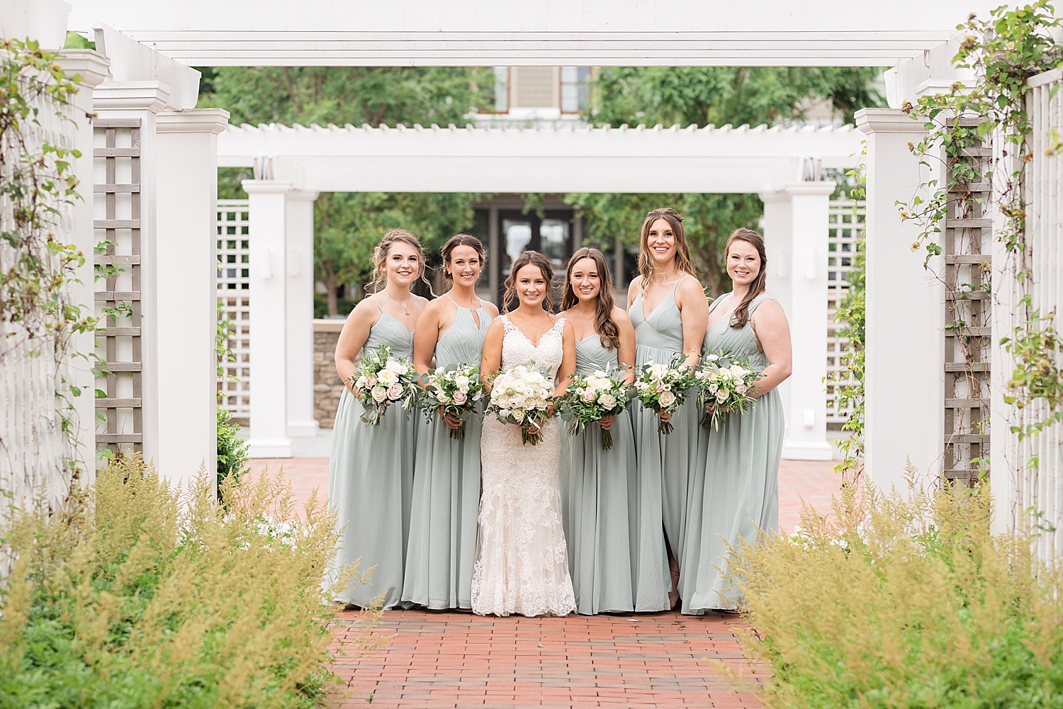 bride and bridesmaids in chesapeake beach club inn courtyard