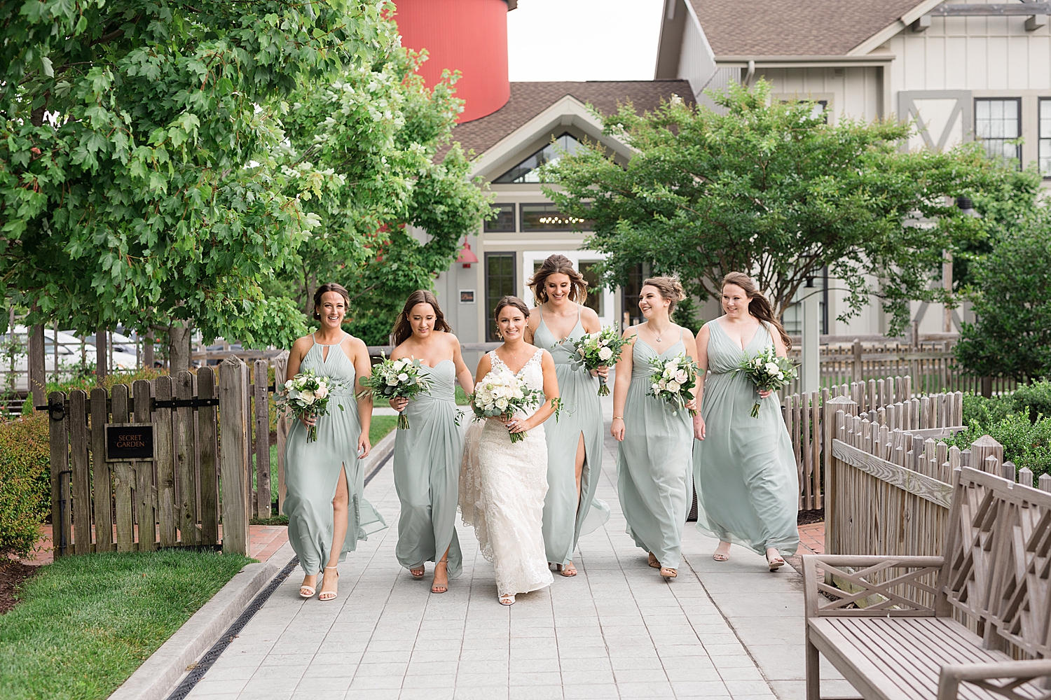 bride and bridesmaids walking through courtyard