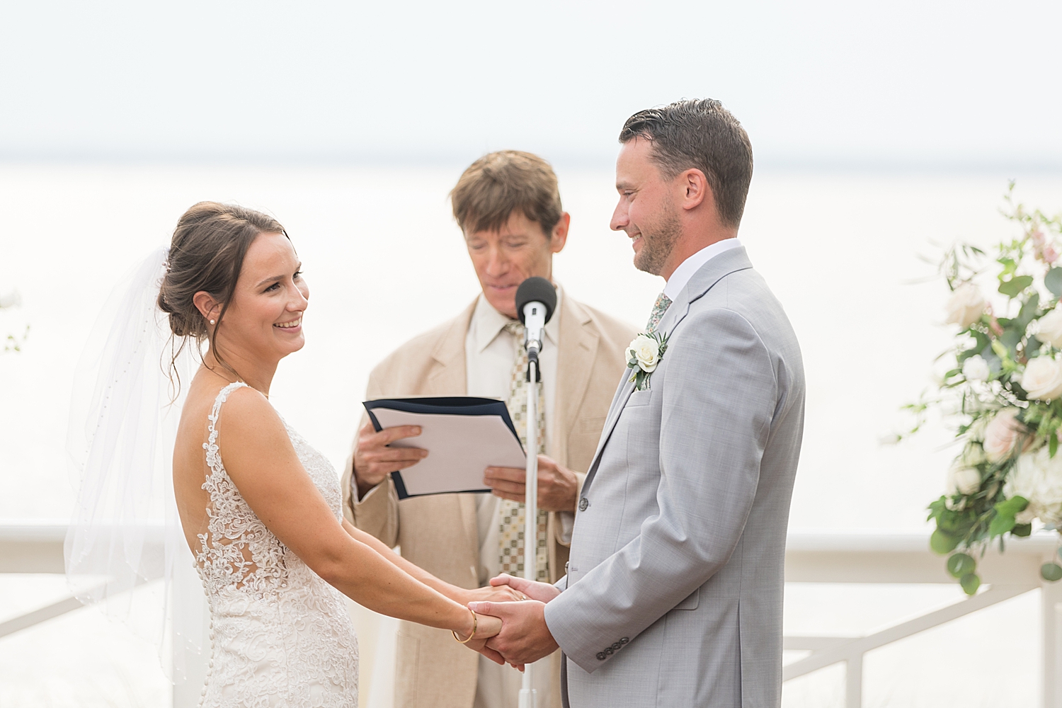 bride and groom holding hands during ceremony