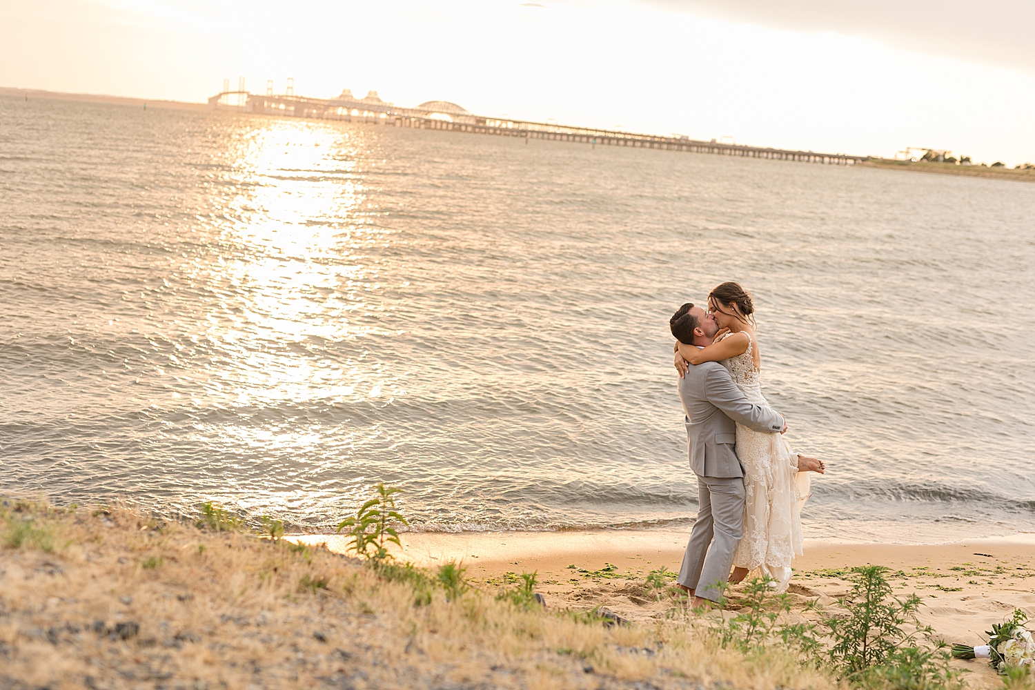 waterfront beach couple portrait kiss sunset