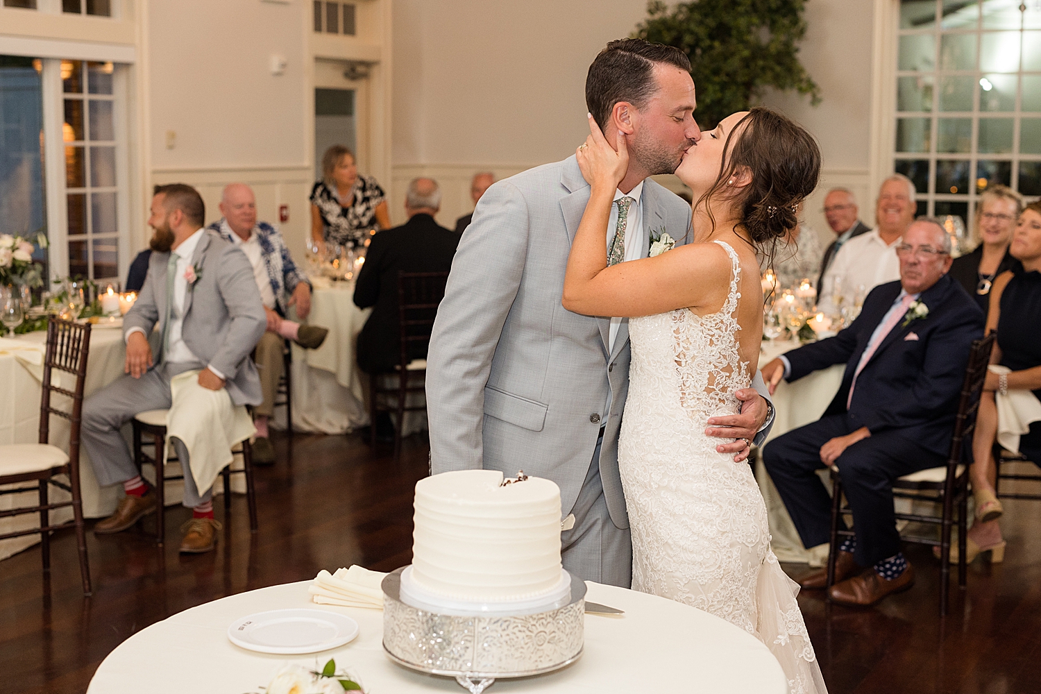 bride and groom kiss after cake cutting