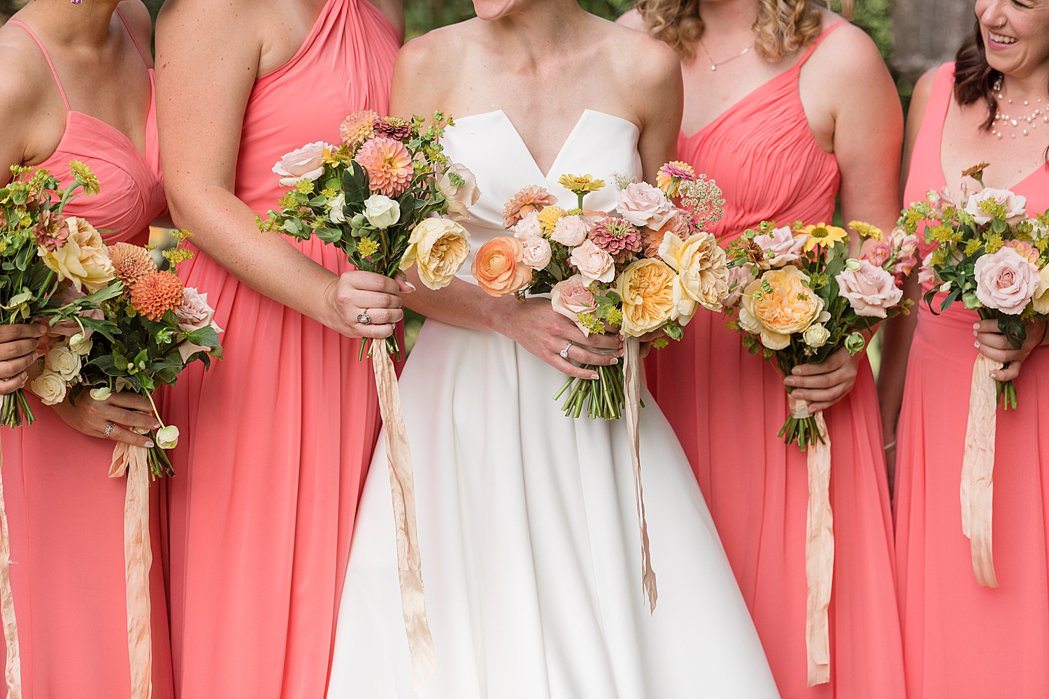 coral bridesmaids dresses and pastel bouquets