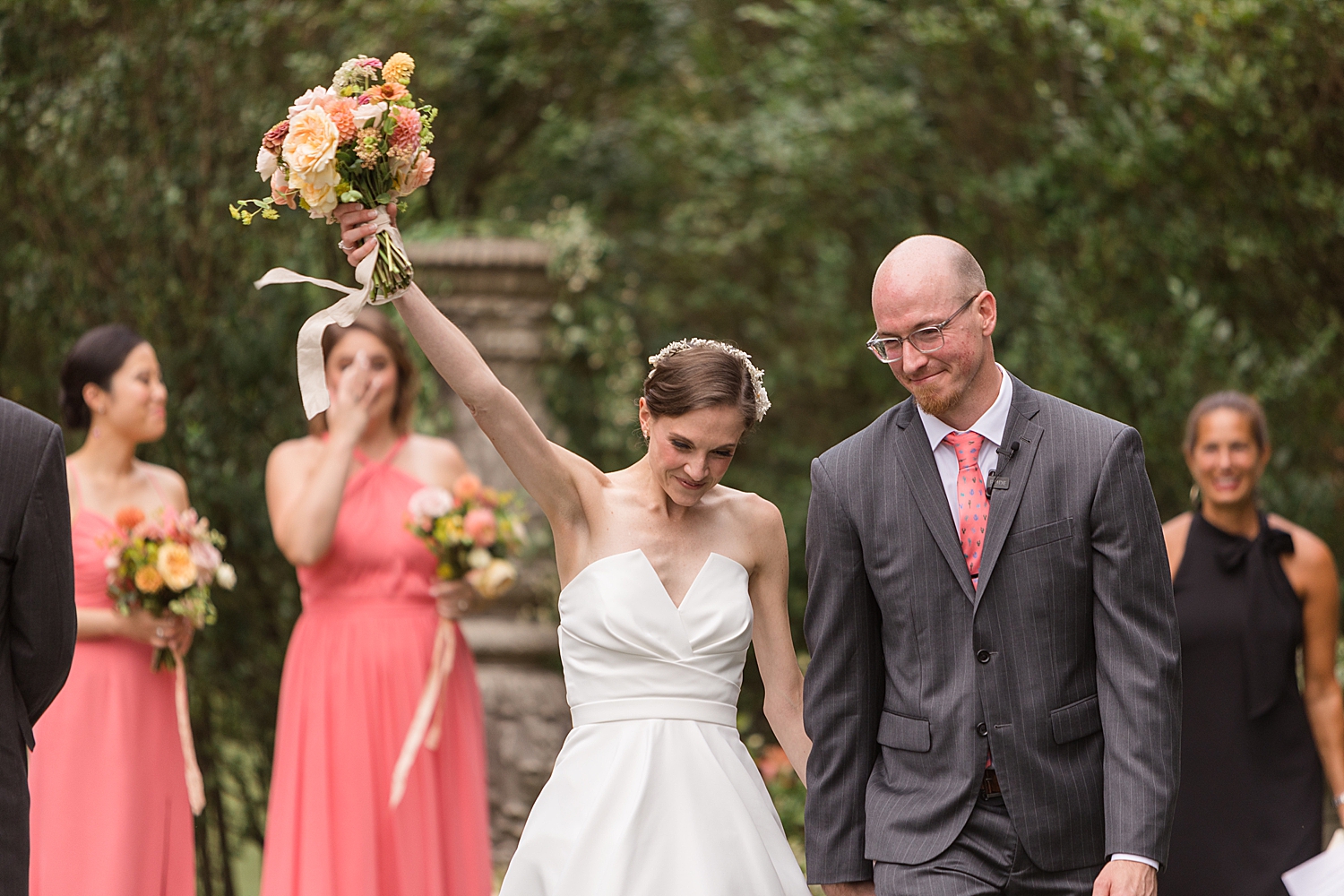 bride and groom celebrate as they recess