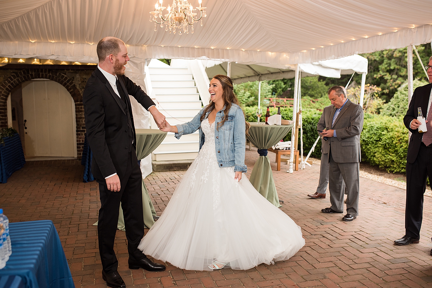 bride and groom dancing under tent