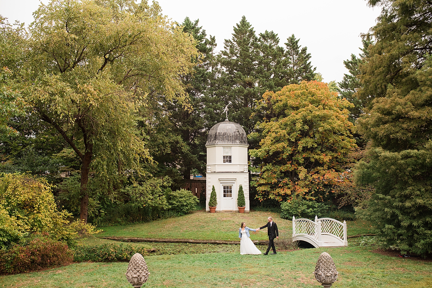 bride and groom walk across paca garden lawn