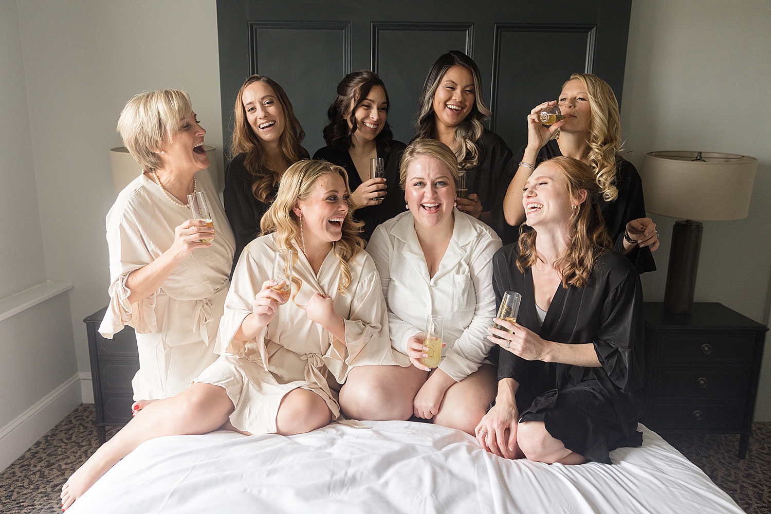 bride and bridesmaids getting ready, robes on bed