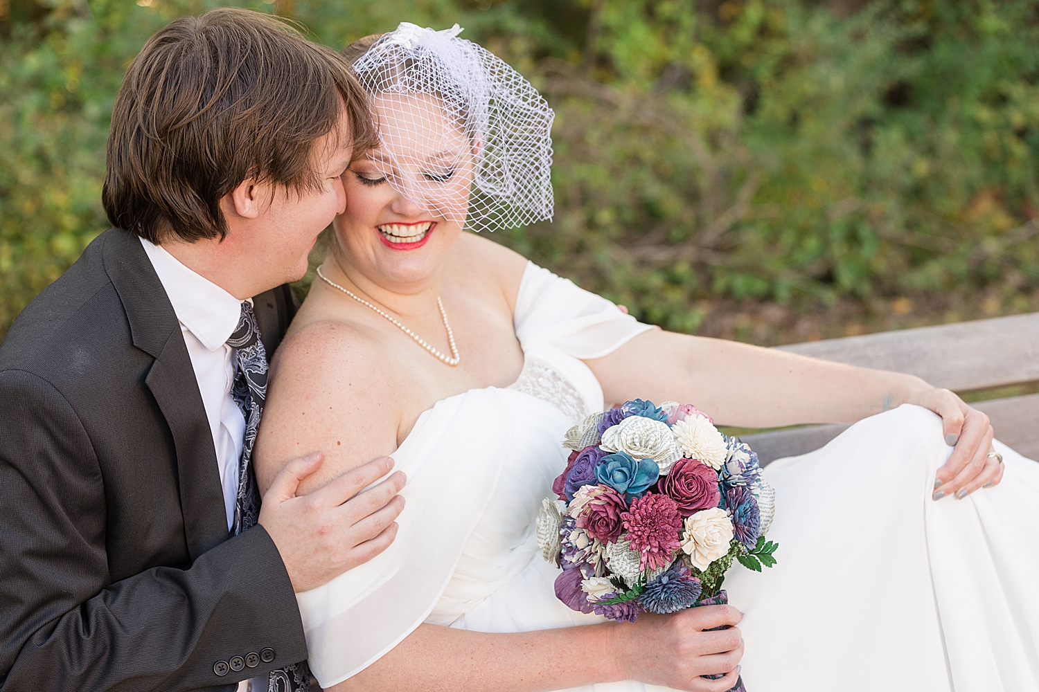 bride and groom portrait wearing white netted fascinator hat