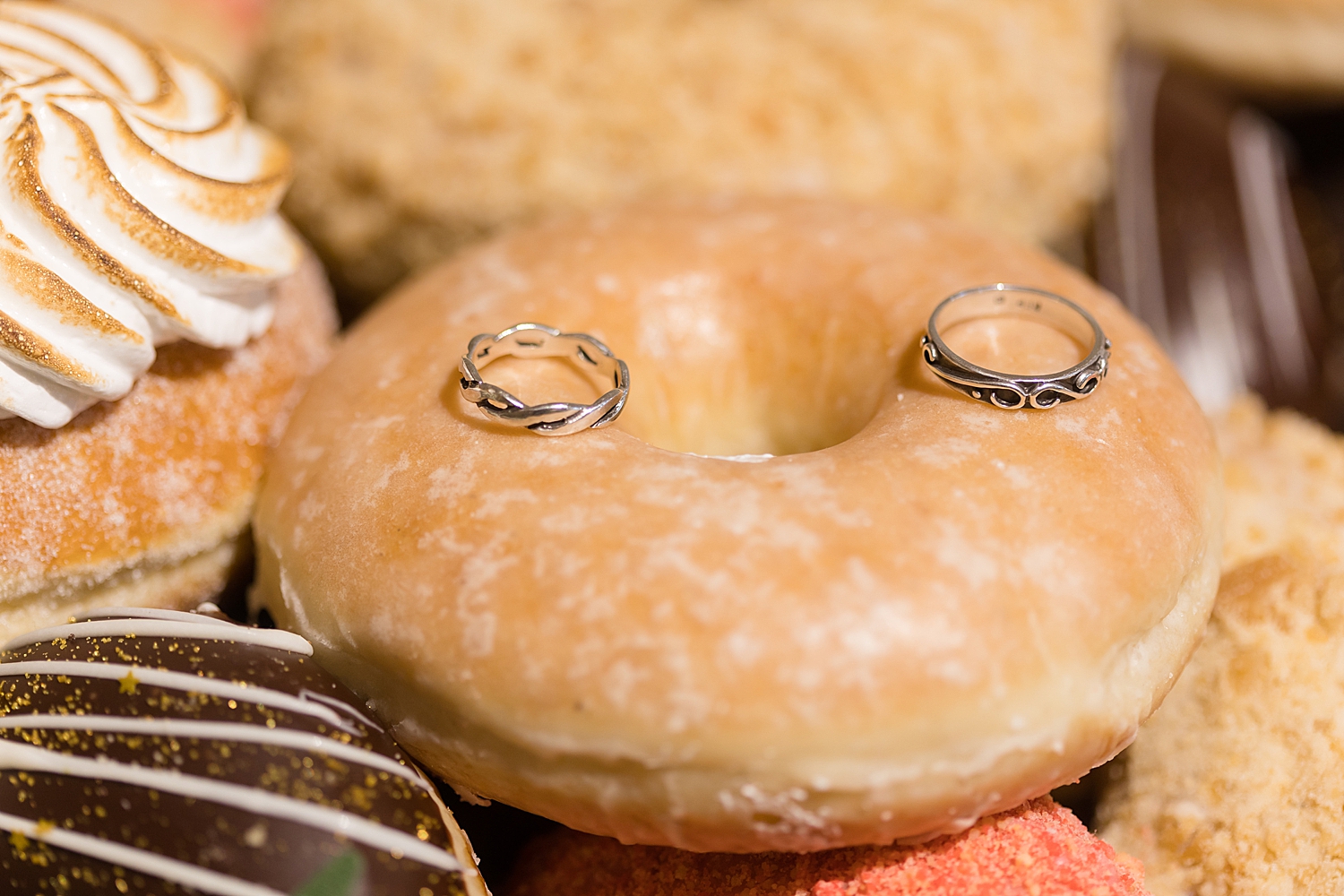 wedding rings on glazed donut