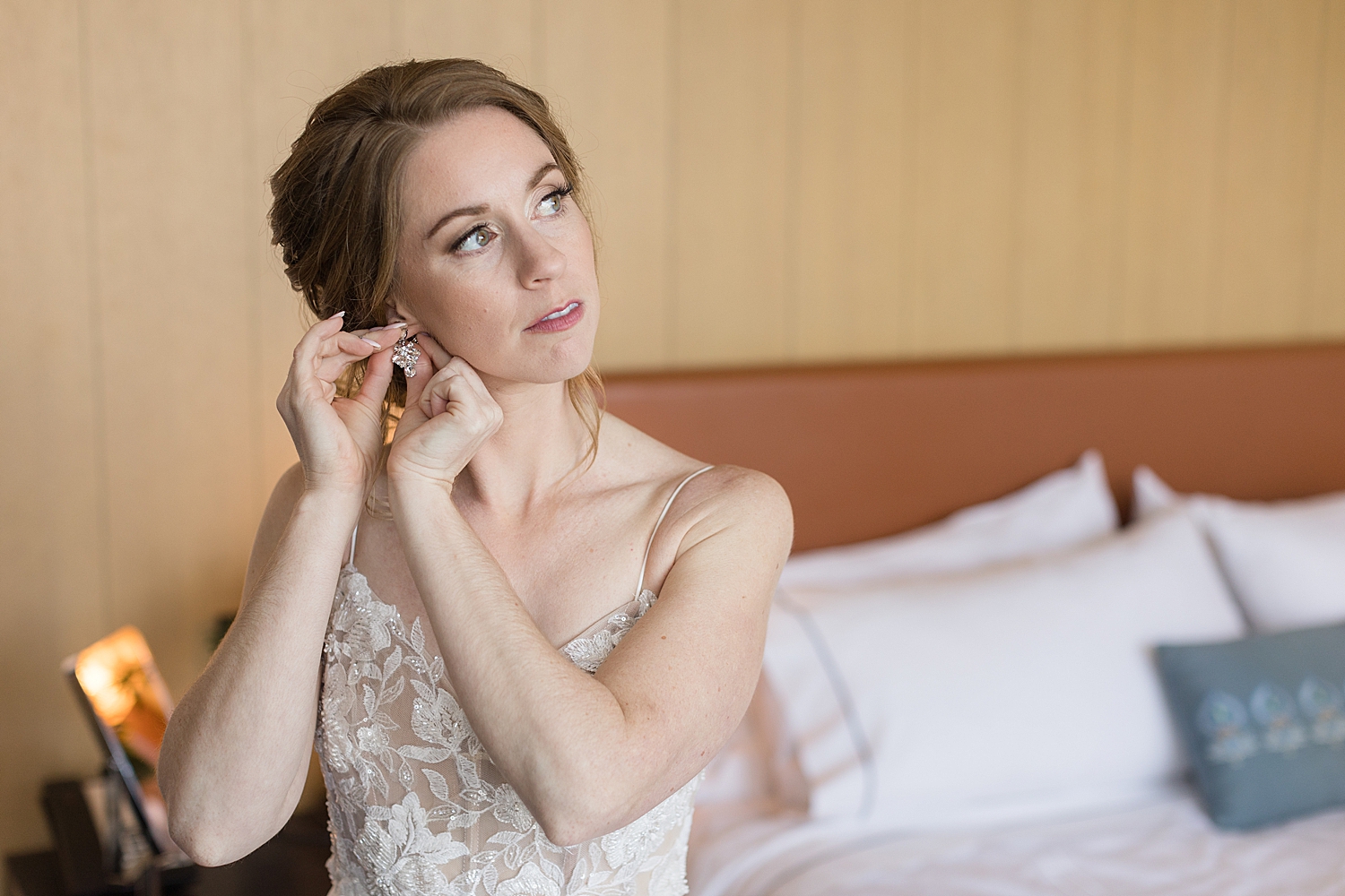 bride putting earrings in