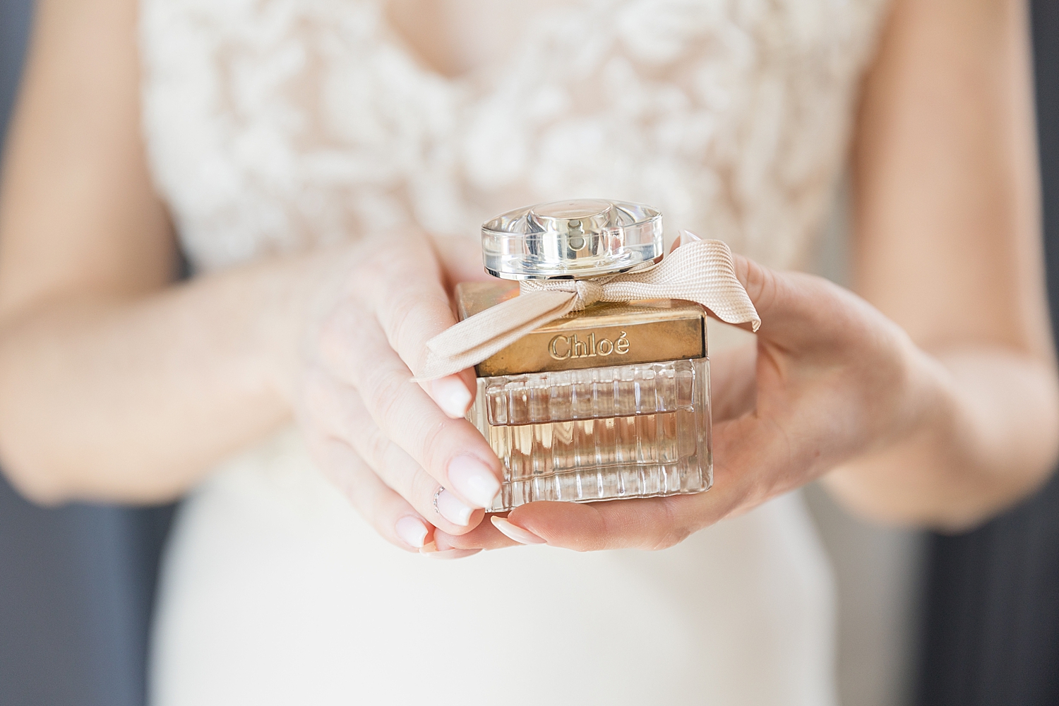 bride holding chloe perfume