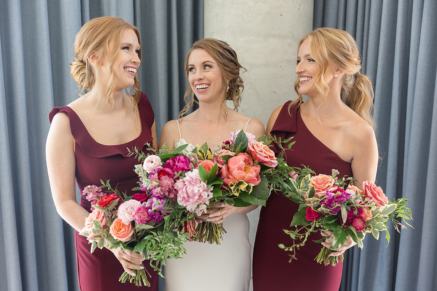 bride with her sisters in red dresses