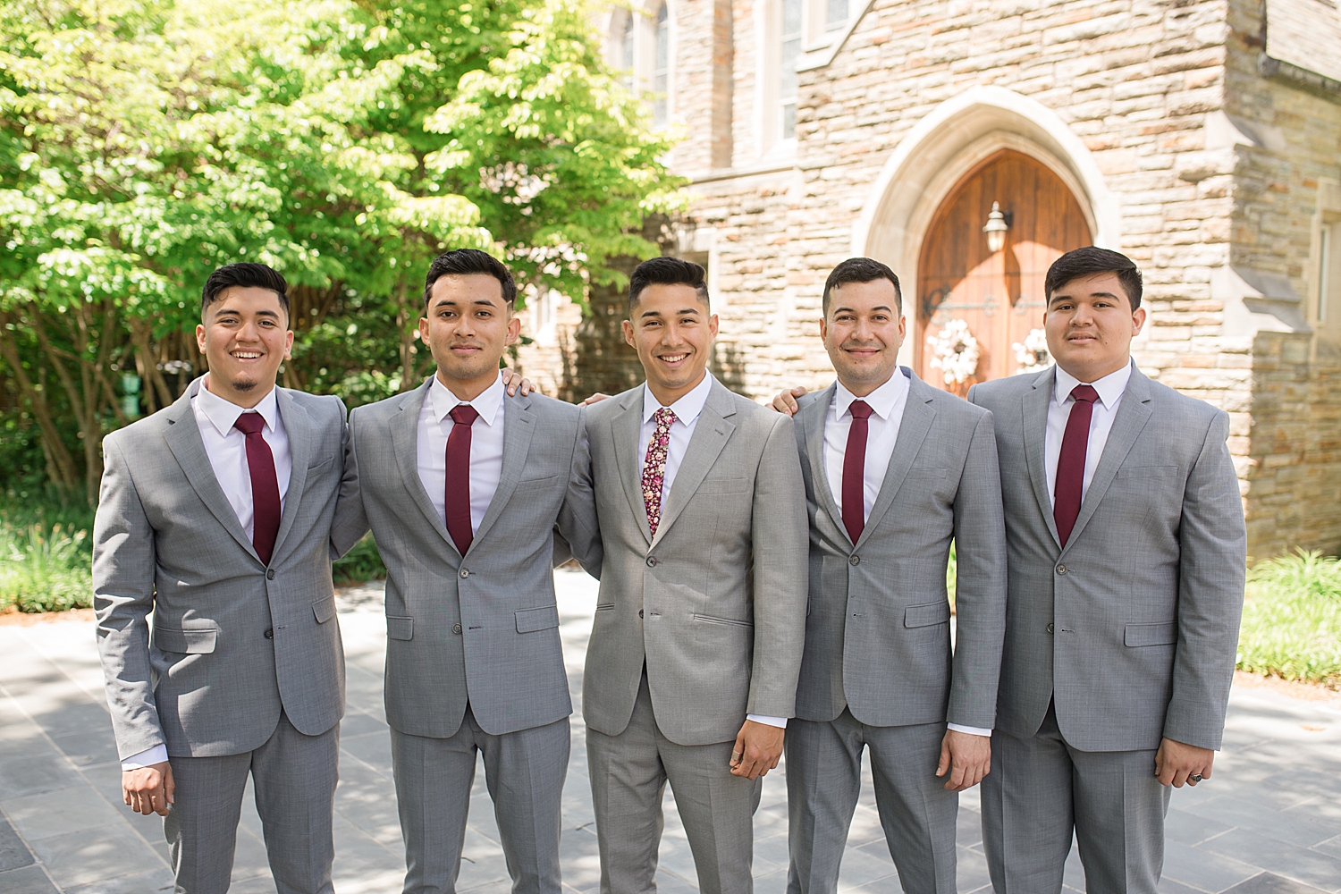 groom and groomsmen portrait in front of chapel