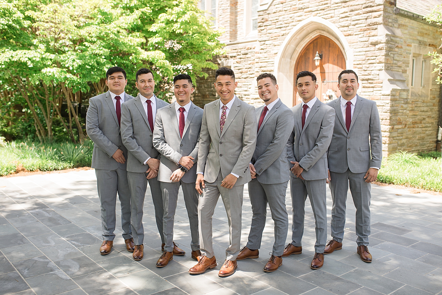 groom and groomsmen portrait in front of chapel