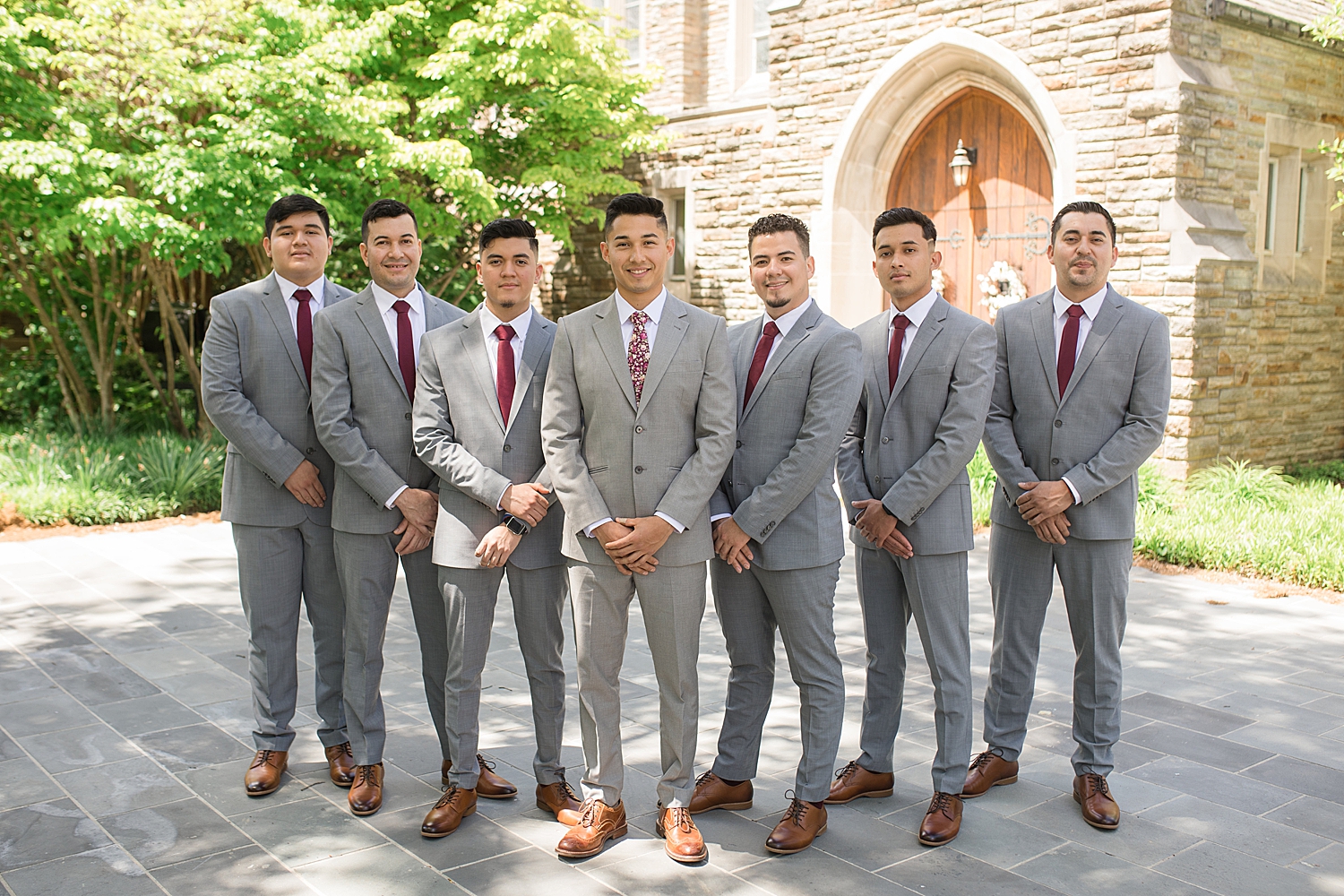 groom and groomsmen portrait in front of chapel