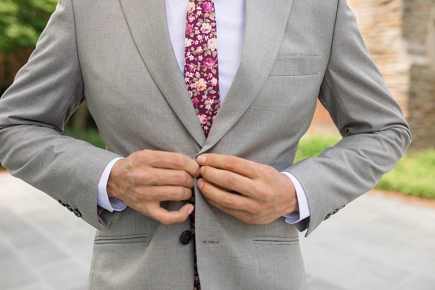 groom buttons gray jacket with red floral tie