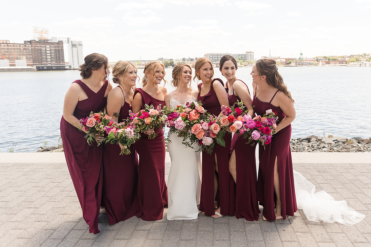 bride and bridesmaids in red dresses at inner harbor