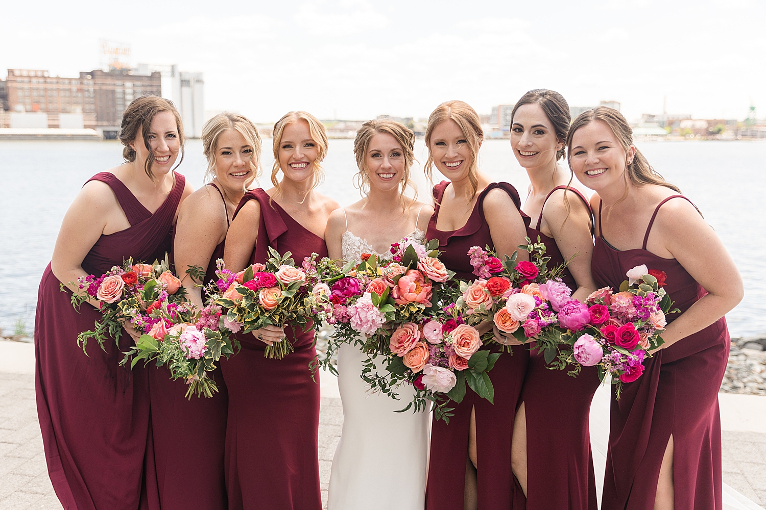 bride and bridesmaids in red dresses at inner harbor