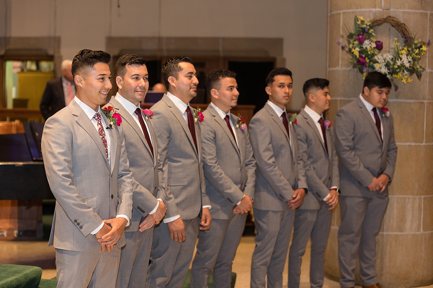 groom waits at the end of the aisle