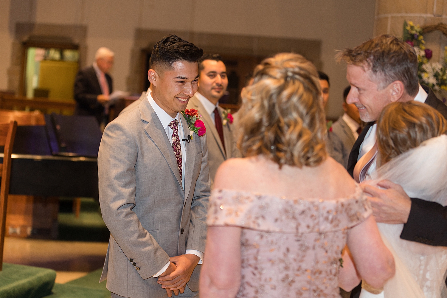 bride's parents giving her away during ceremony