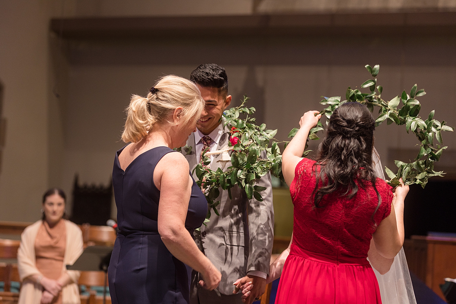 bride and groom draped in greenery