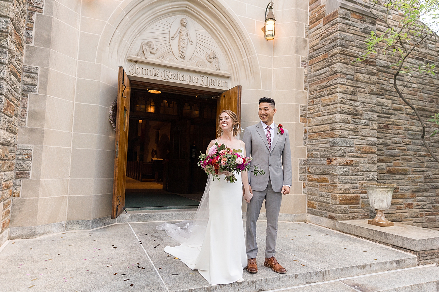 bride and groom in front of chapel