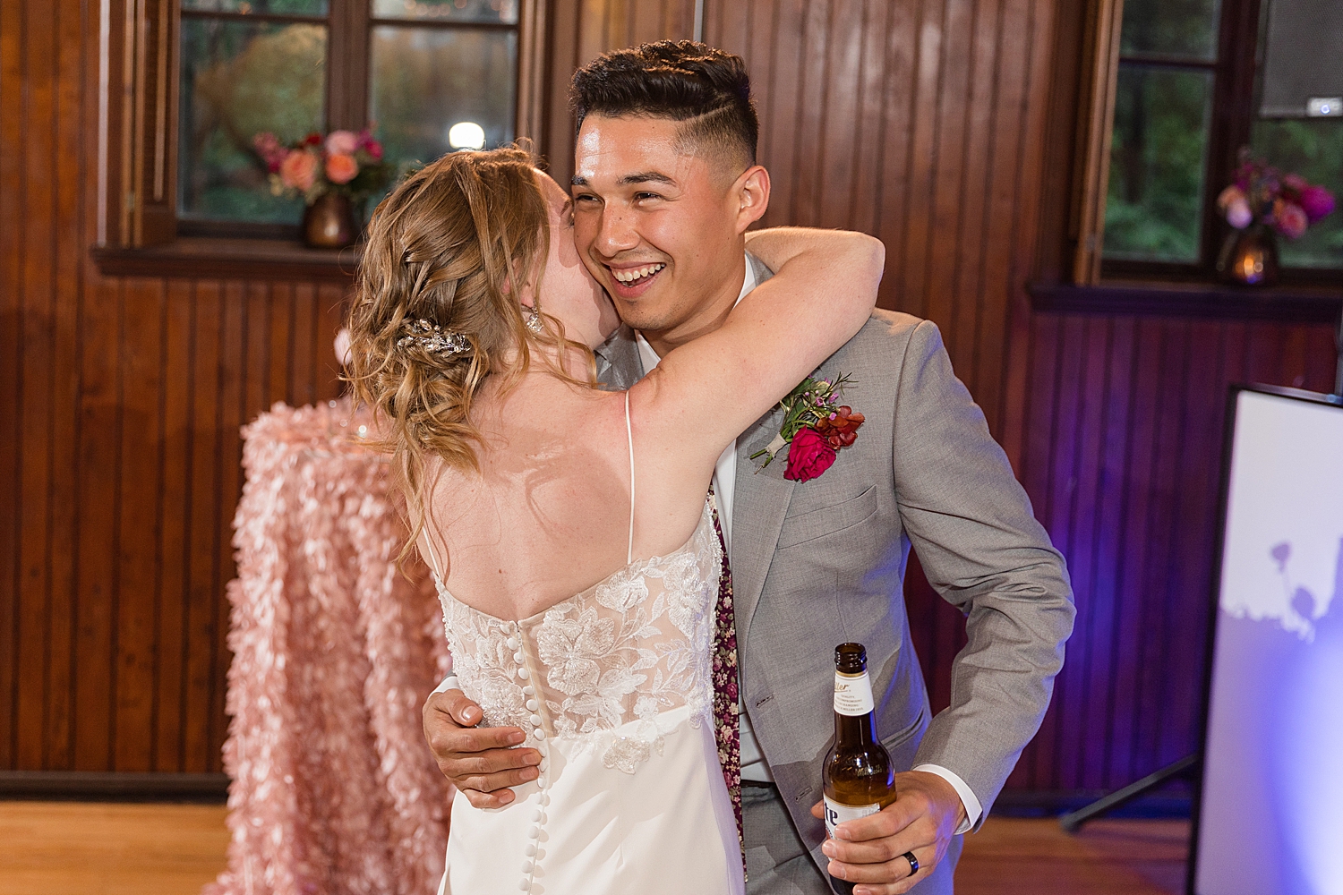 bride kisses groom on the cheek on the dancefloor