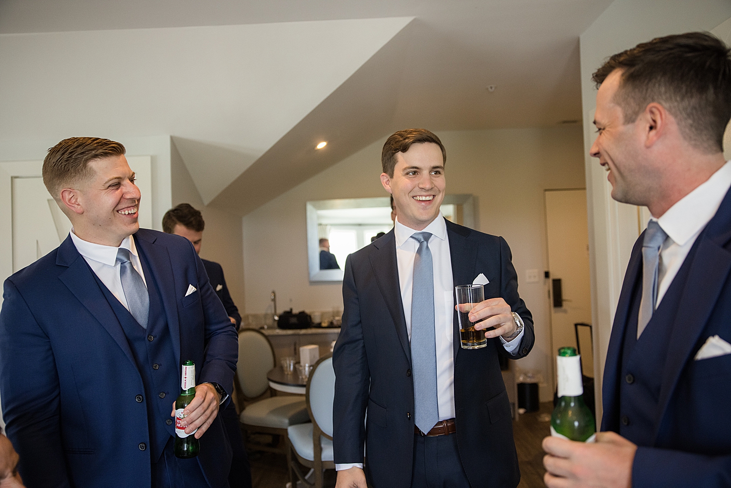 groom holding beers with groomsmen