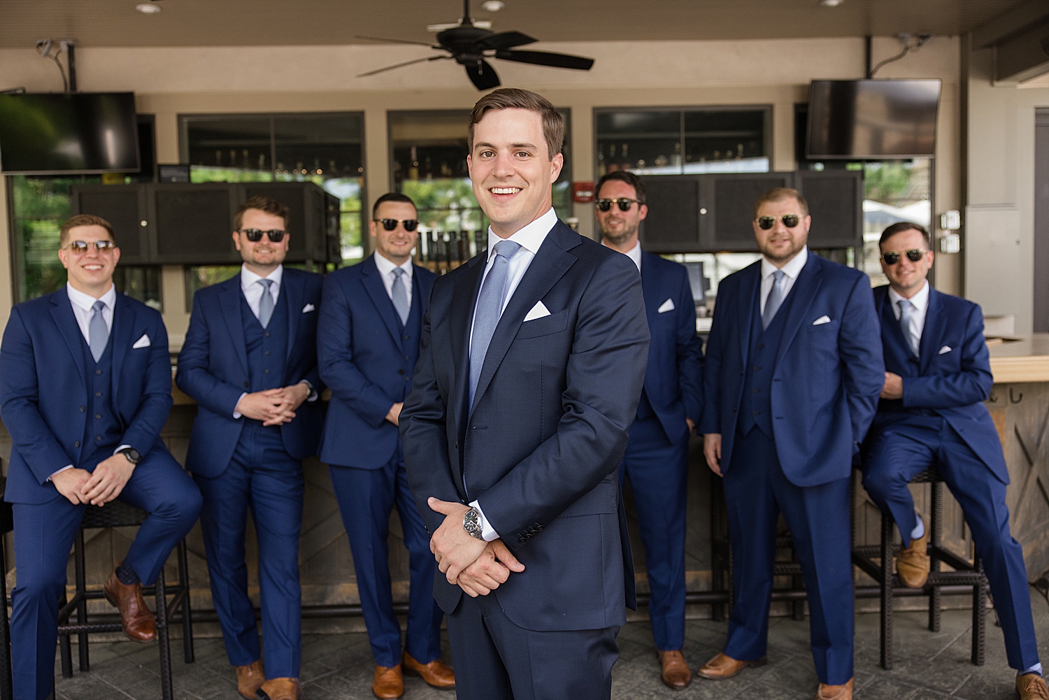 groom and groomsmen hang out at bar