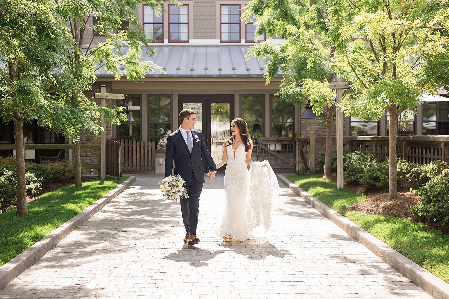 bride and groom walk together in courtyard