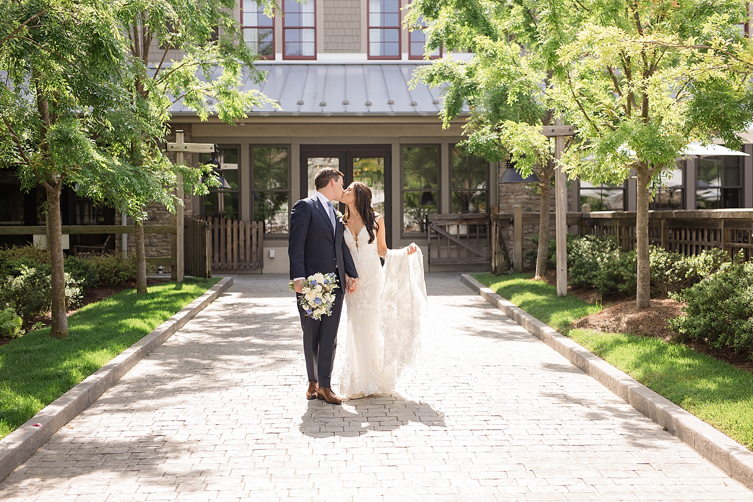 bride and groom walk together in courtyard