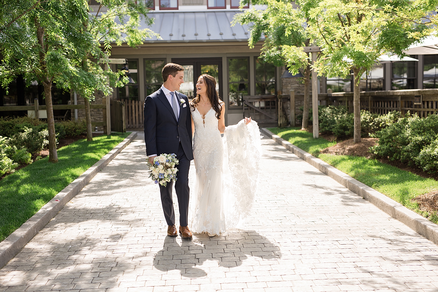 bride and groom walk together in courtyard