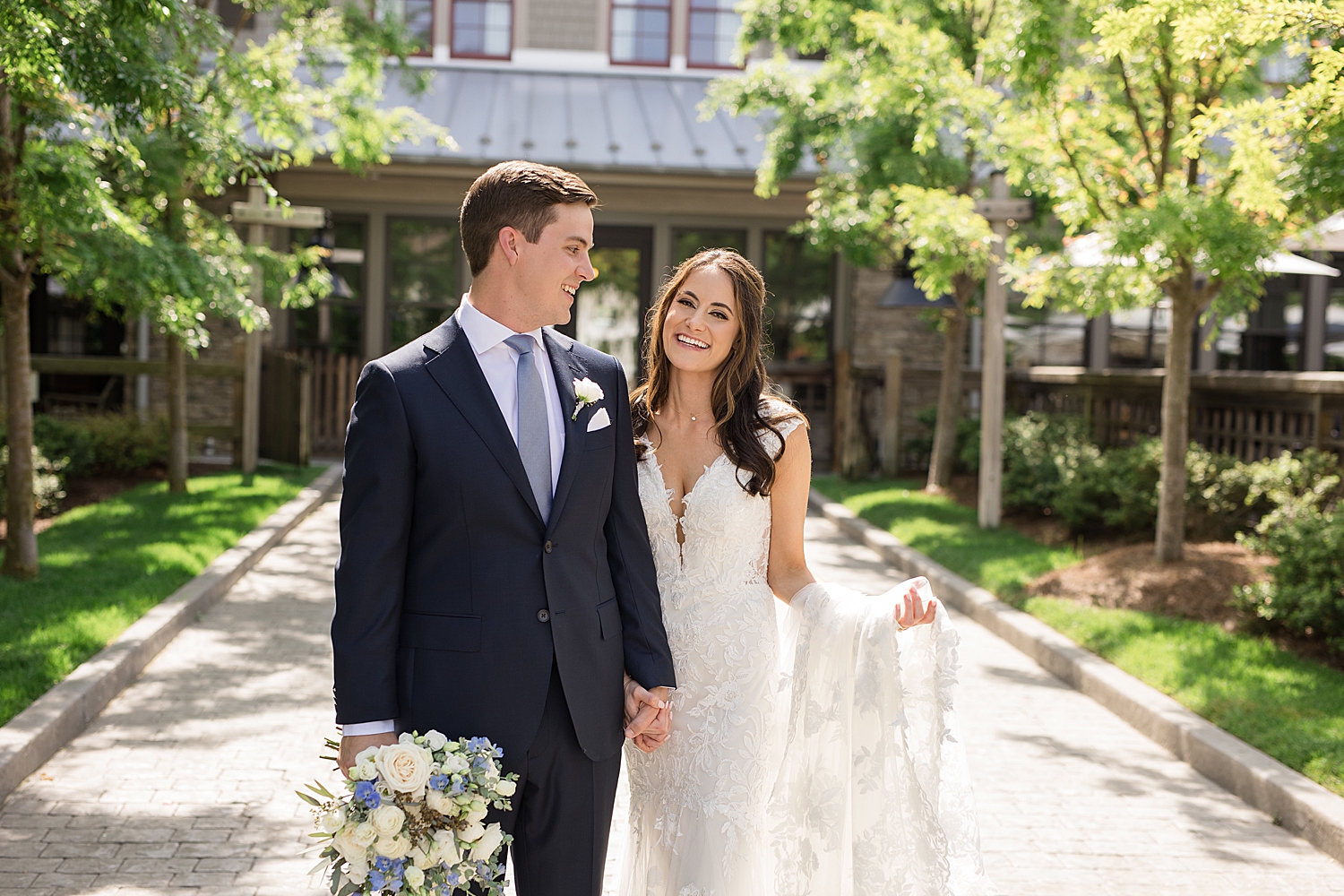 bride and groom walk together in courtyard