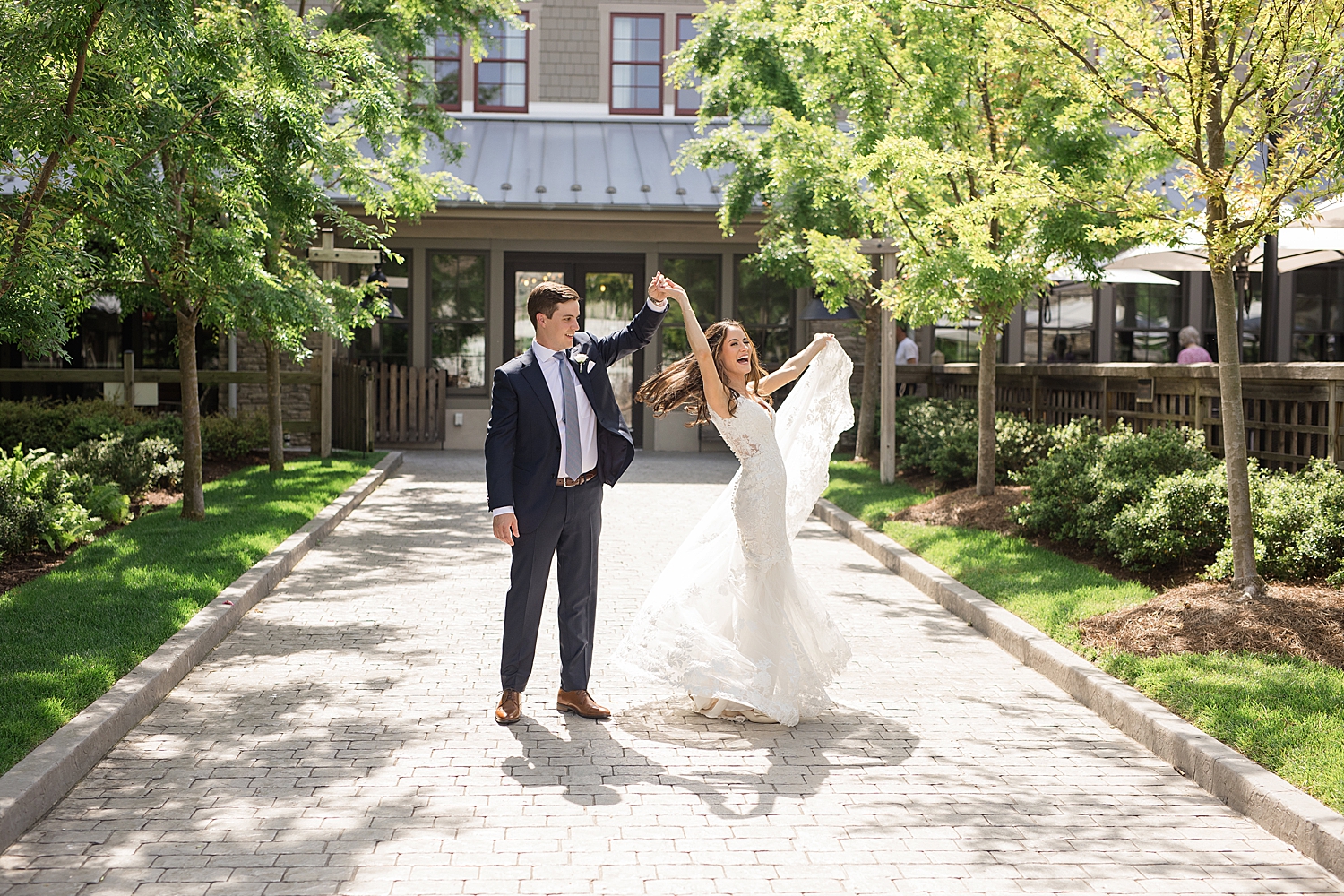 bride and groom spin in courtyard