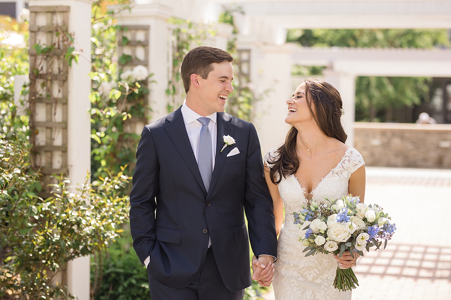 bride and groom laugh in chesapeake bay beach club courtyard