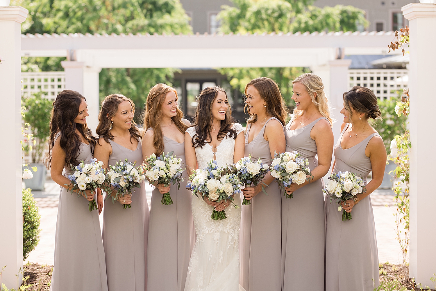 bride and bridesmaids smile at each other