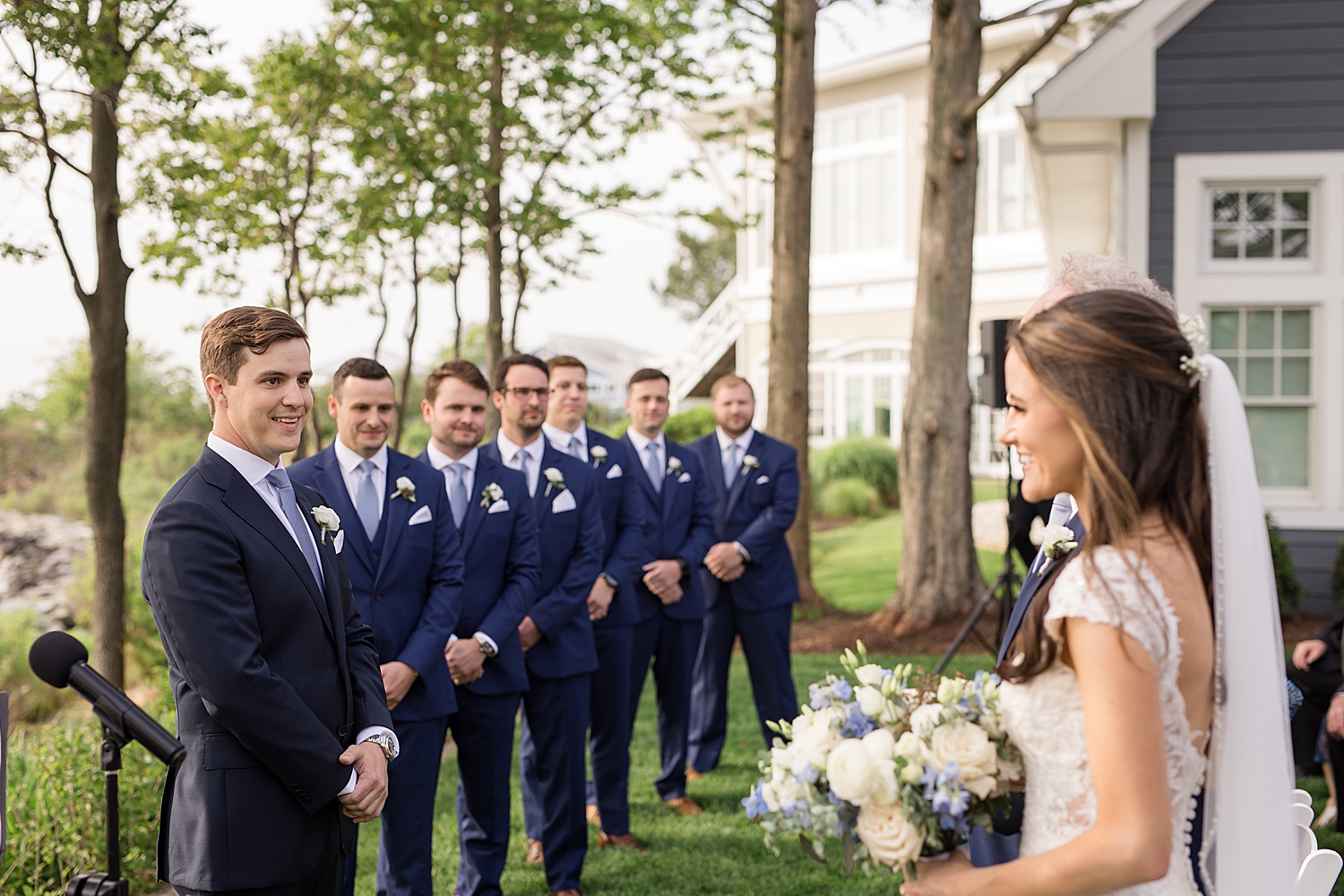 bride reaches groom at the end of aisle