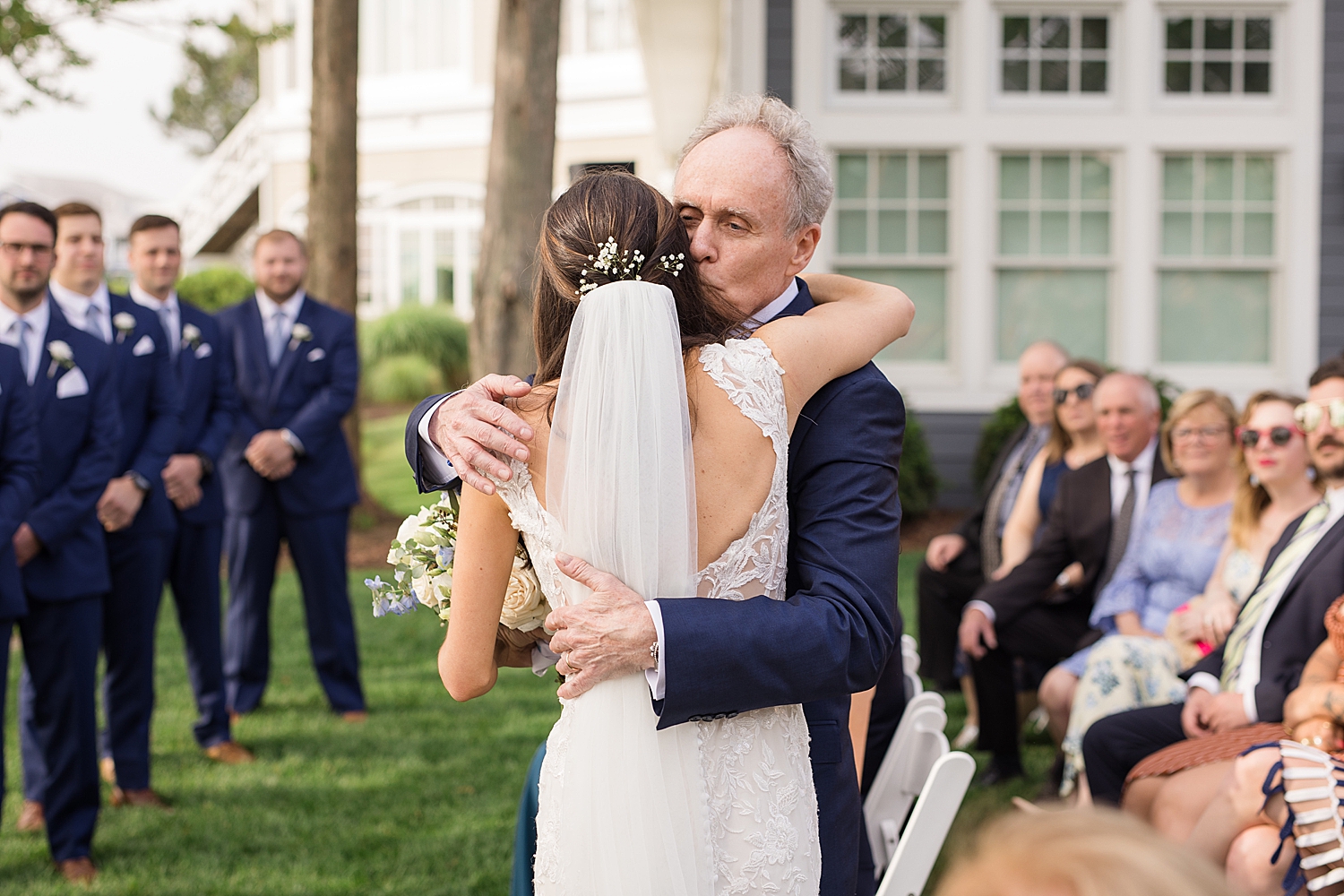 bride hugs dad during ceremony