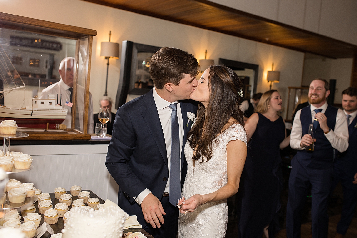 bride and groom kiss after cake cutting