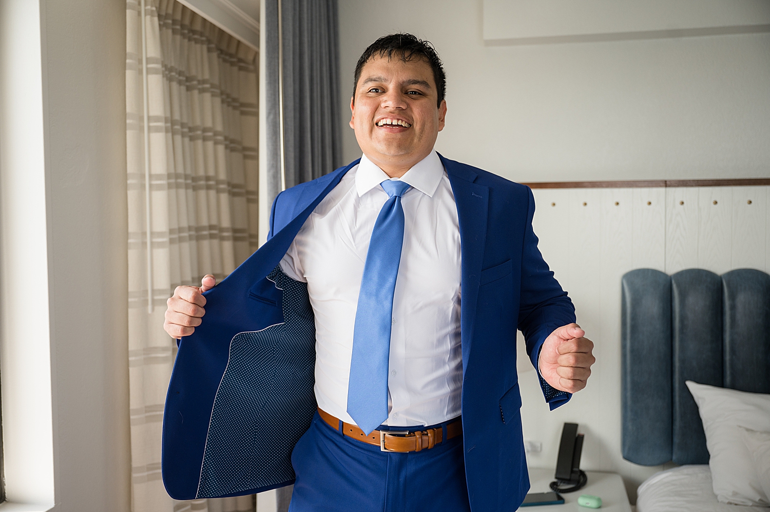 groom getting ready blue suit and tie